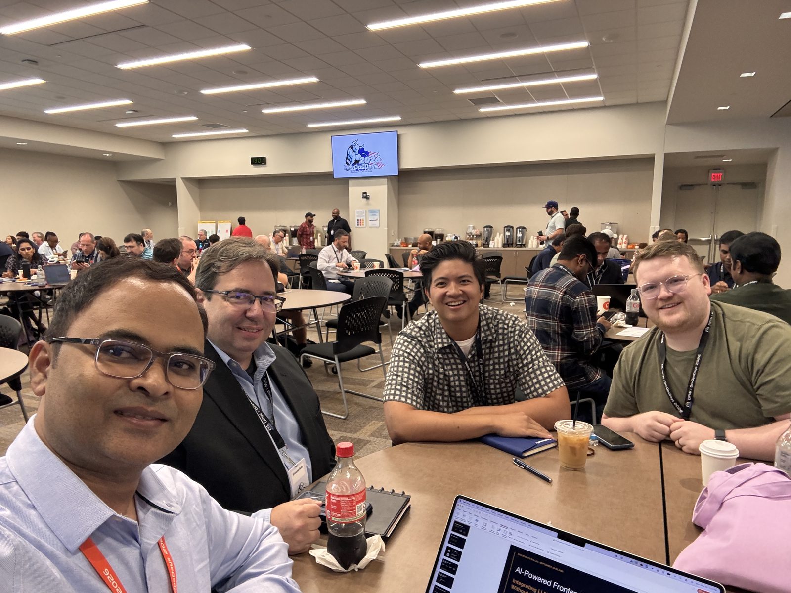 Sayeed Mohammad with attendees before the talk, the AI-Powered Frontend deck open on a laptop